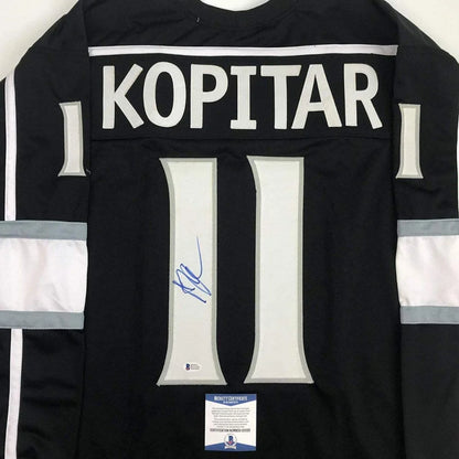 Black hockey custom jersey of Anze Kopitar with signed blue ink memorabilia