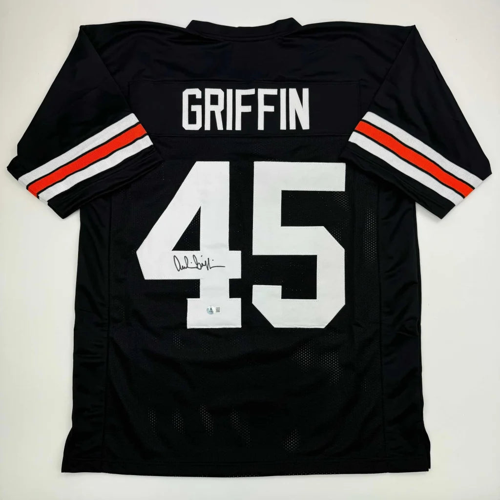 Black custom jersey with white numbers and orange striped sleeves for professional sports fans