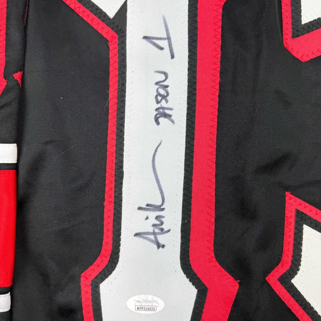 Autographed black and red chicago bulls jersey with white stripe featuring signature from friday the 13th actor ari lehman