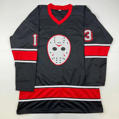 Black hockey jersey with red and white accents featuring a central white hockey mask graphic signed by ari lehman