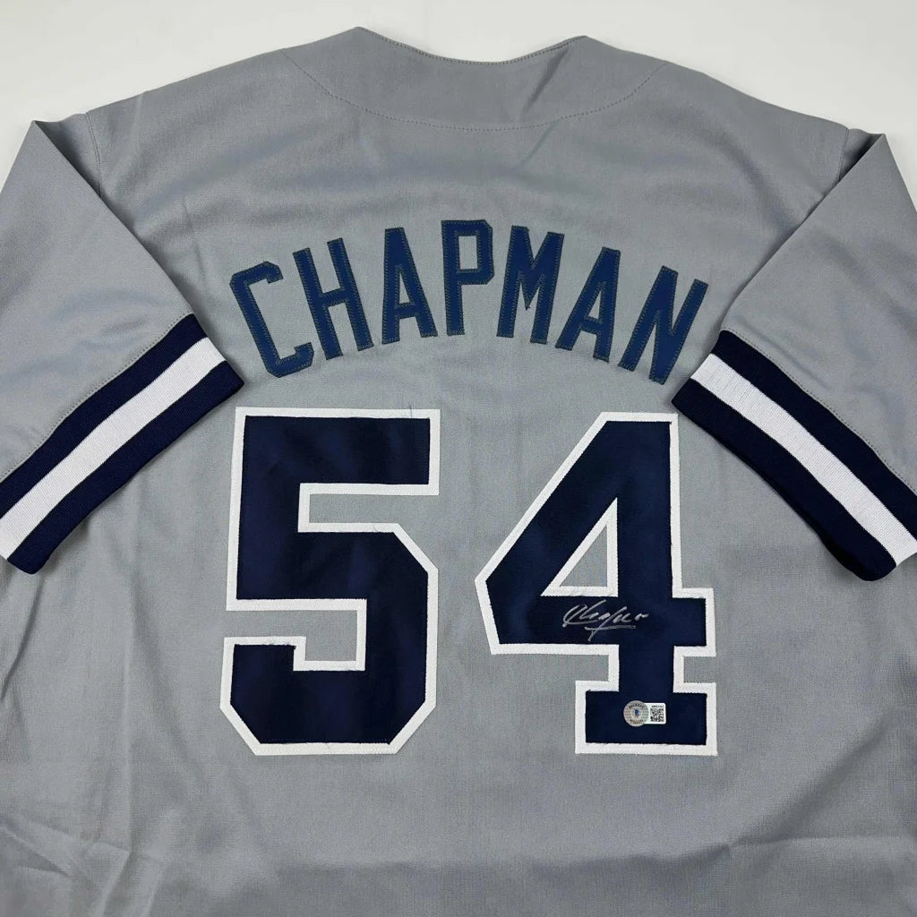 Gray custom jersey with Chapman 54 autographed, navy blue and white striped sleeves