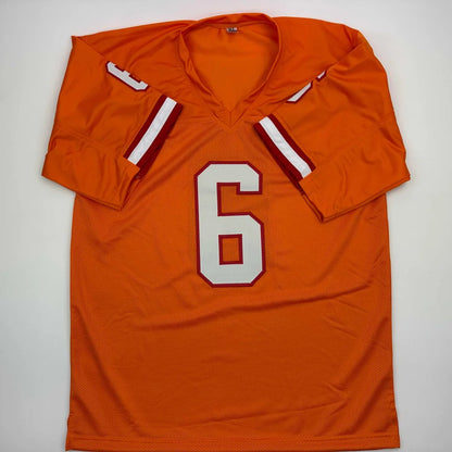 Autographed Baker Mayfield custom jersey in vibrant orange with white and maroon trim for professional sports league fans
