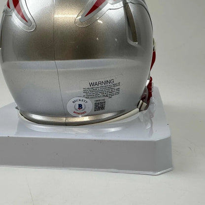 Silver New England Patriots mini helmet with red and white stripes and third party authentication