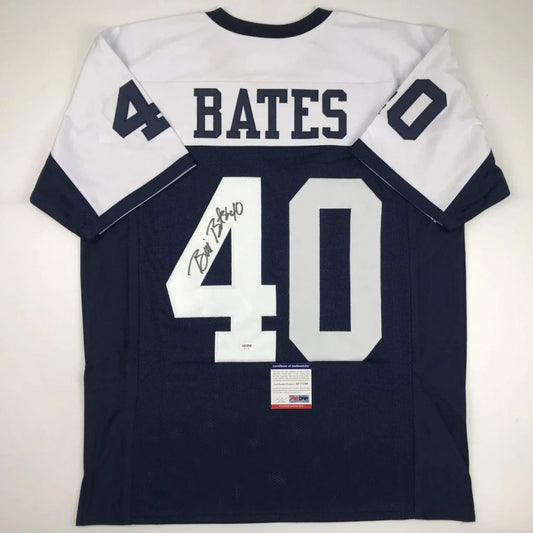 Back view of navy blue and white custom football jersey signed by bill bates from professional sports league with psa dna coa