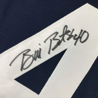 Navy blue and white custom athletic jersey with bold diagonal stripe and black ink autograph from professional sports league player bill bates