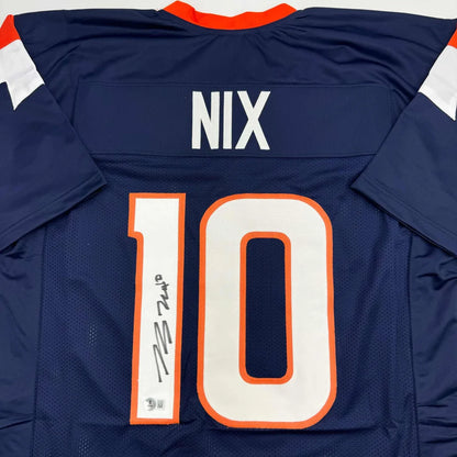 Back of navy blue autographed bo nix football jersey with orange white accents and custom professional sports league number 10