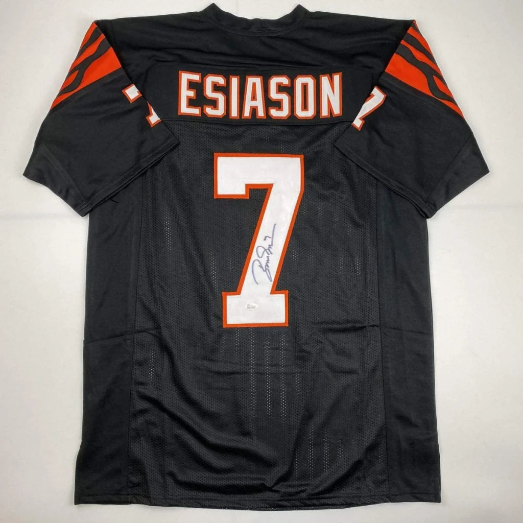 Back of a black custom boomer esiason football jersey with orange and white lettering number 7 from professional sports league