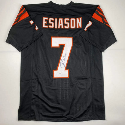 Back of a black custom boomer esiason football jersey with orange and white lettering number 7 from professional sports league