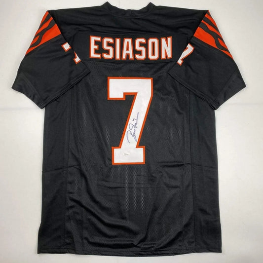 Back of a black custom boomer esiason football jersey with orange and white lettering number 7 from professional sports league