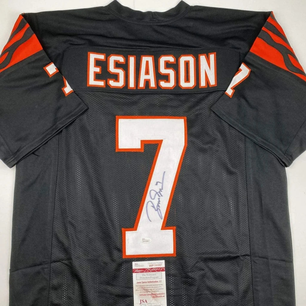 Back of black custom football jersey with orange white lettering esiason 7 autographed with JSA COA from professional sports league