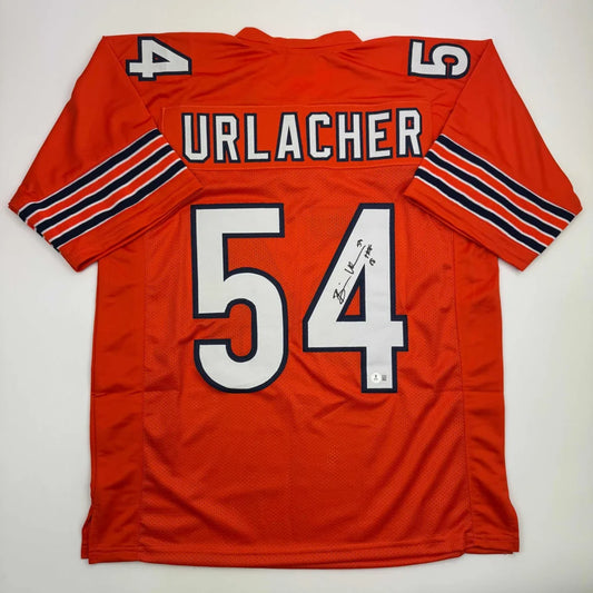 Back of an autographed orange chicago bears custom jersey with white and navy trim featuring urlacher 54 for professional sports league fans