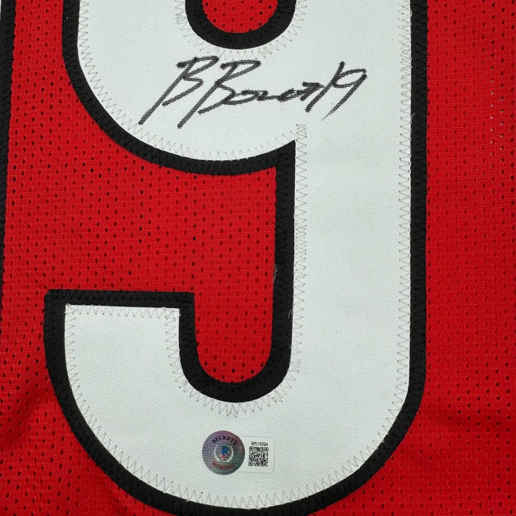 Red and white mesh custom jersey with black trim and bold number 9 signed by brock bowers from a professional sports league