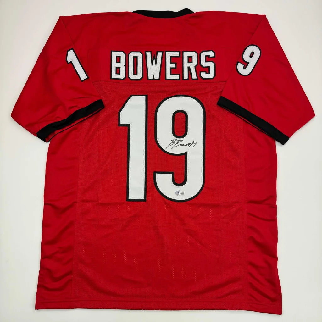 Back of a red georgia college football custom jersey signed by player bowers featuring white and black lettering number 19