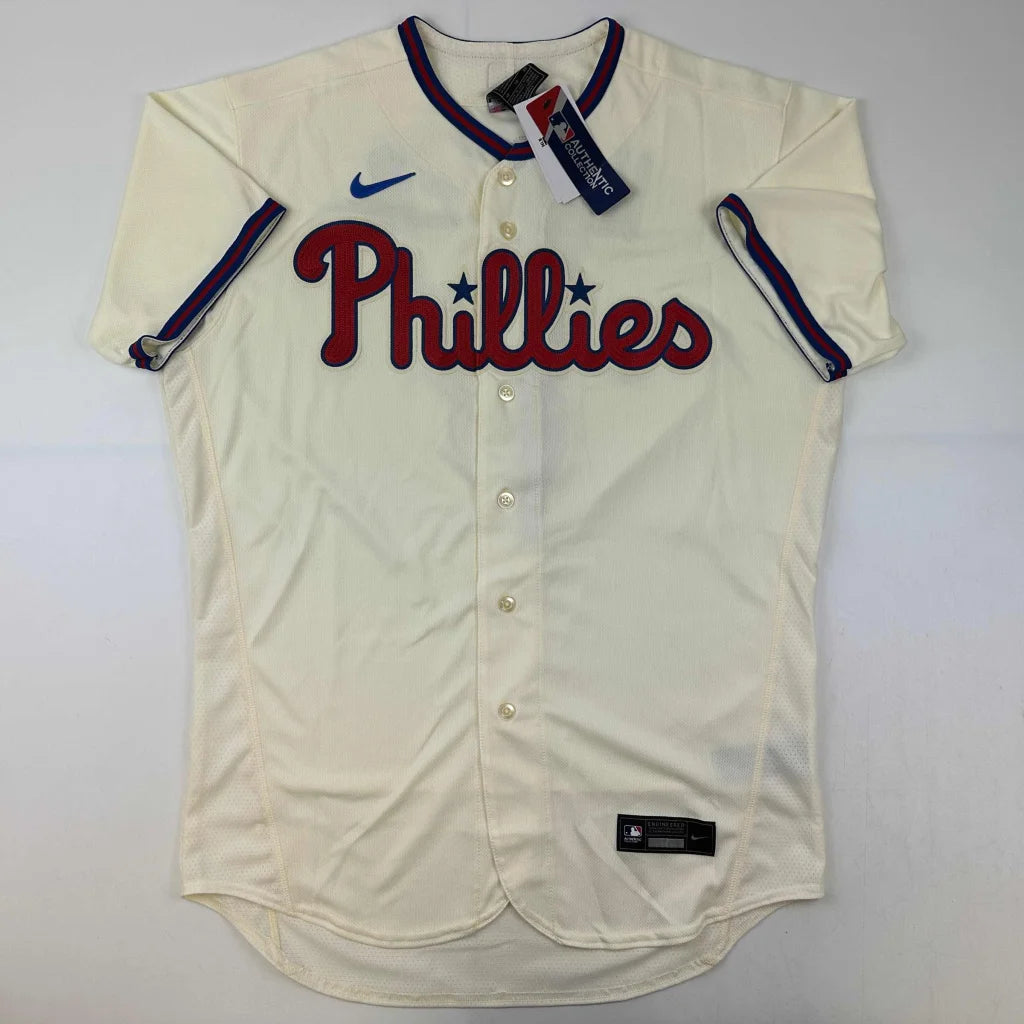 Cream-colored Phillies baseball jersey with red lettering, signed by Bryce Harper