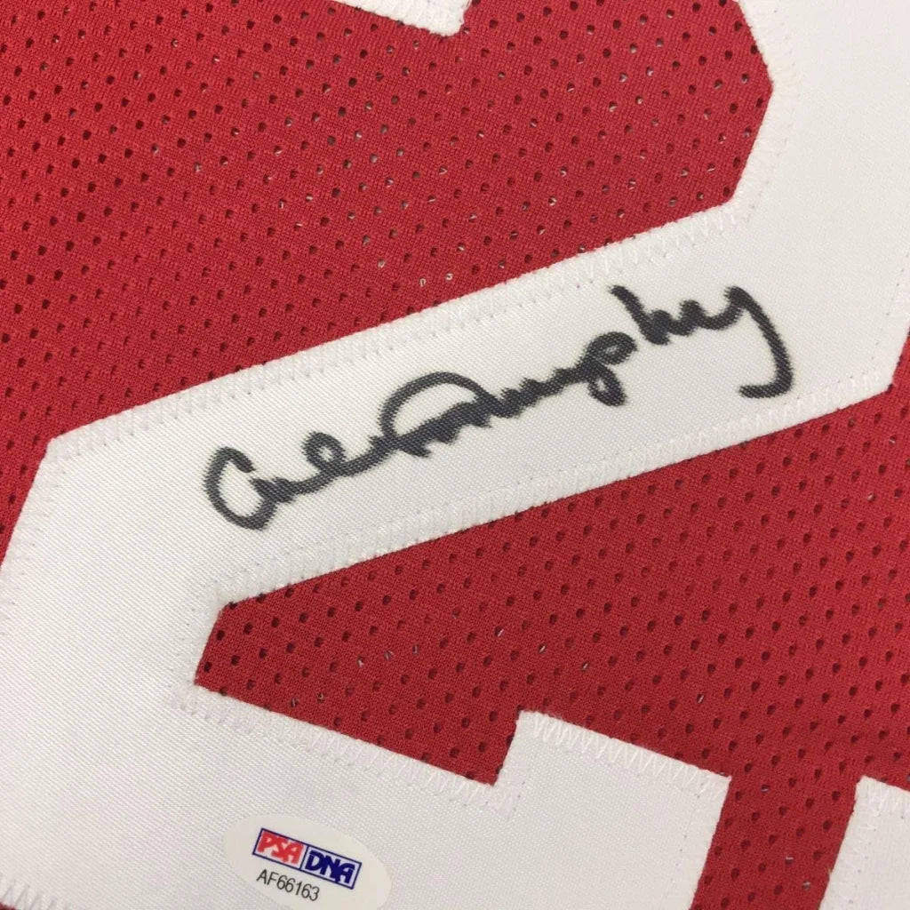 Red athletic jersey with white number and autograph, verified with third party authentication