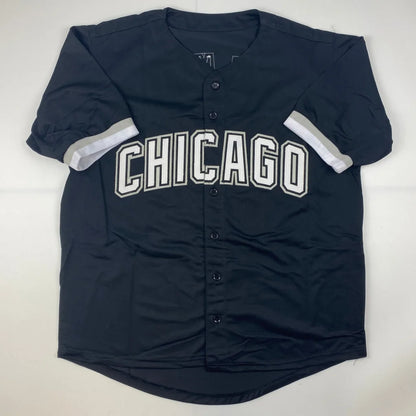 Black Chicago baseball jersey with white lettering and striped sleeves, perfect for professional sports fans