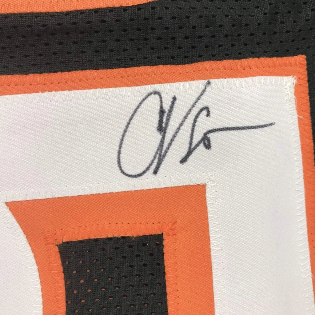 Autographed black custom jersey with orange and white trim from professional sports league