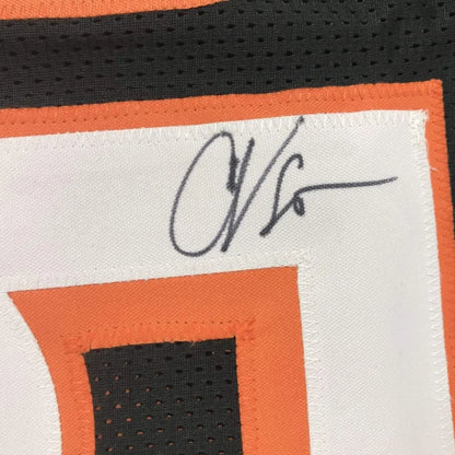 Autographed black custom jersey with orange and white trim from professional sports league