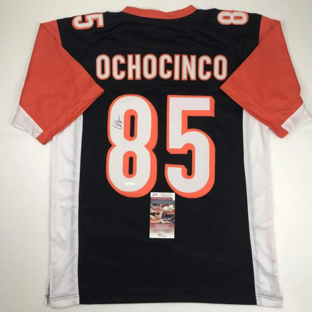 Black and orange Ochocinco 85 custom jersey with autograph and authenticity sticker, perfect for NFL fans