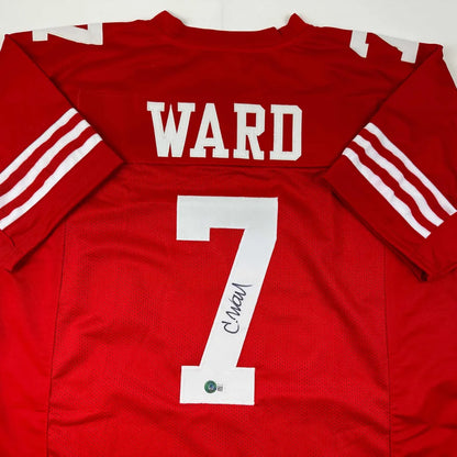 Back of an autographed San Francisco 49ers red custom jersey with white ward 7 lettering from professional sports league