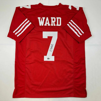 Back of red custom football jersey signed by charvarius ward with white lettering and stripes from professional sports league