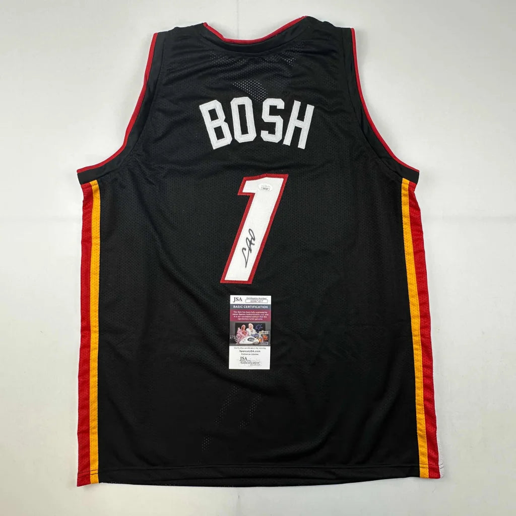 Signed Black Miami Heat Chris Bosh #1 jersey with autograph and authentication sticker for professional sports fans