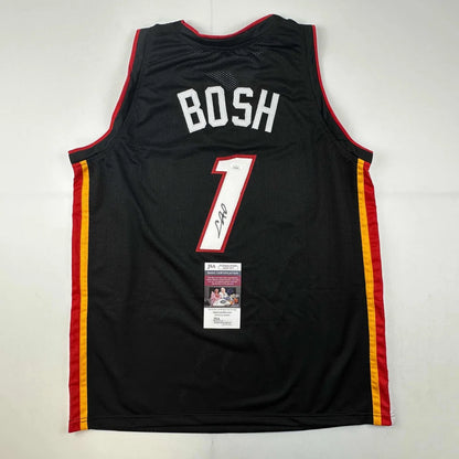 Signed Black Miami Heat Chris Bosh #1 jersey with autograph and authentication sticker for professional sports fans