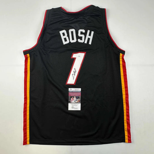 Signed Black Miami Heat Chris Bosh #1 jersey with autograph and authentication sticker for professional sports fans