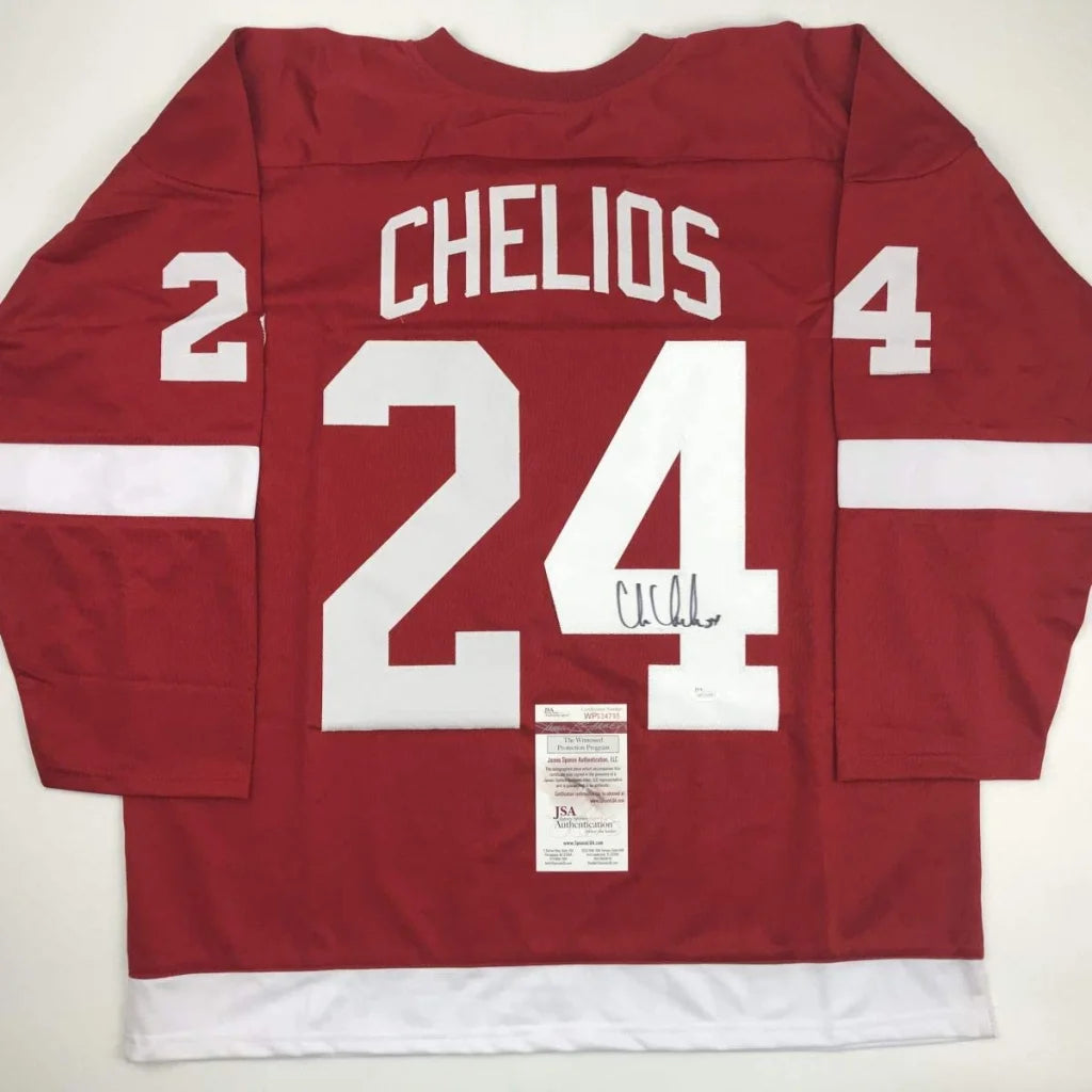 Red autographed chris chelios hockey jersey with white lettering number 24 from professional sports league, custom jersey