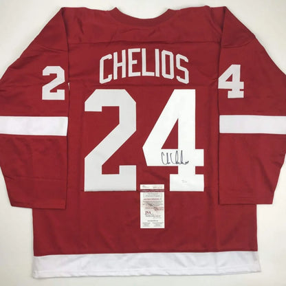Red autographed chris chelios hockey jersey with white lettering number 24 from professional sports league, custom jersey