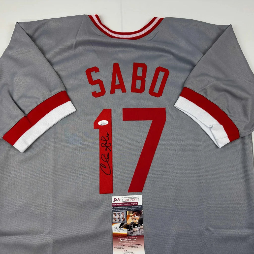 Gray long-sleeved custom jersey with red lettering and striped cuffs from Professional Sports