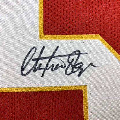 Autographed Christian Okoye custom jersey with black ink signature on white fabric patch, bordered by yellow and red mesh, JSA COA, professional sports league