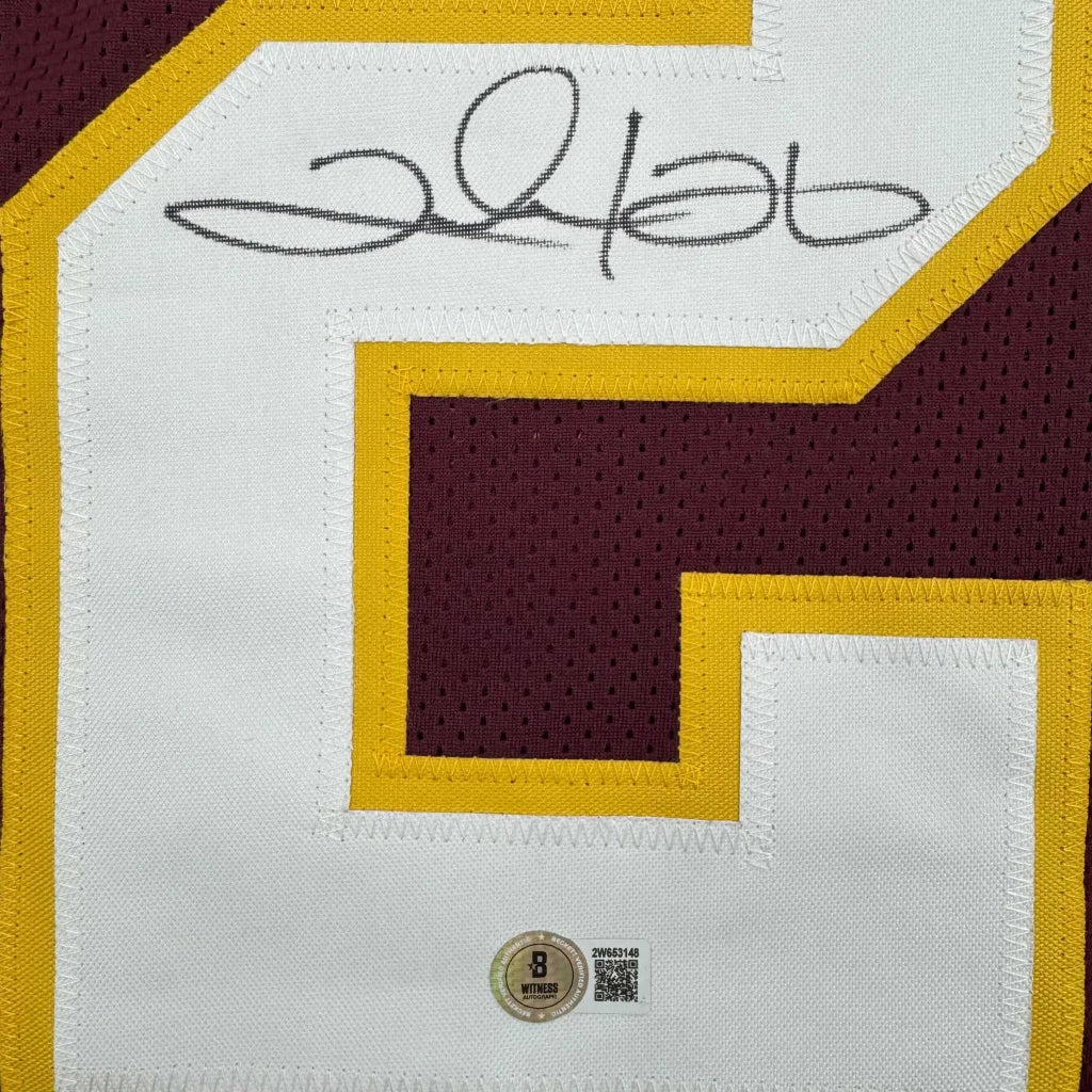 Autographed burgundy and gold custom jersey from a professional sports league