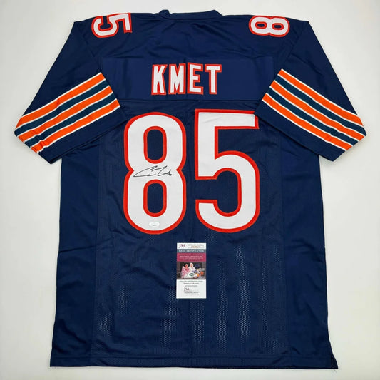 Navy blue custom football jersey with orange and white sleeve stripes featuring kmet 85 in white outlined red, professional sports league collectible