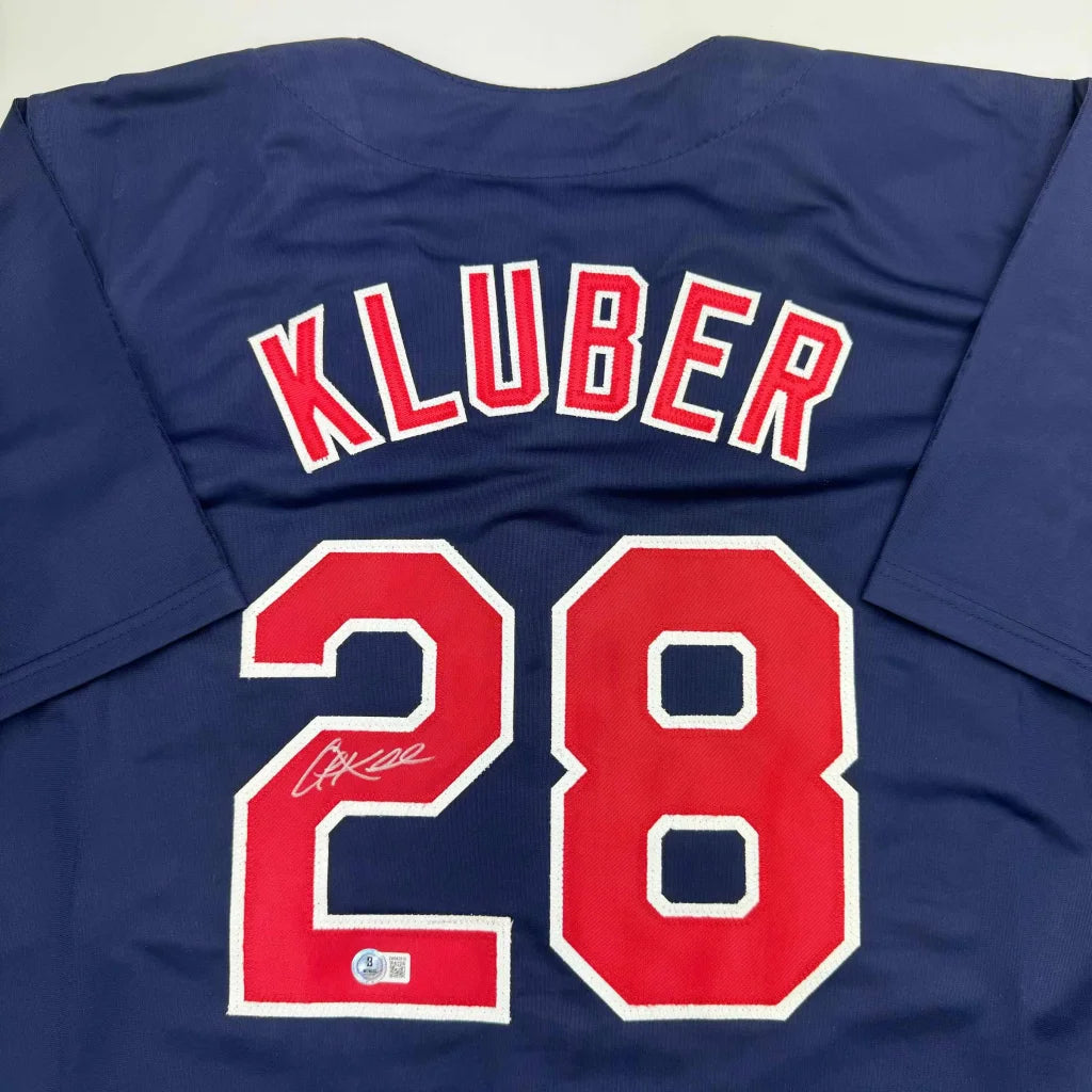 Navy blue professional sports custom jersey with Kluber 28 autograph and authentication sticker