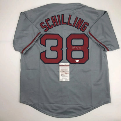Gray custom jersey from professional sports league with Schilling 38 and signed number 8