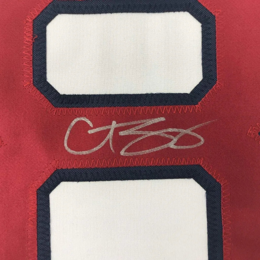 Red custom jersey from professional sports league with blue outlined number and silver autograph