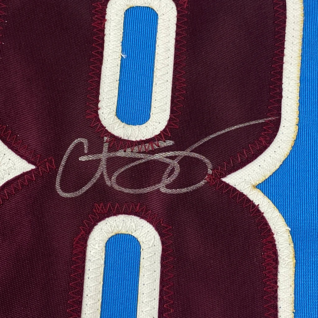 Maroon and blue custom sports jersey with autograph from professional sports league