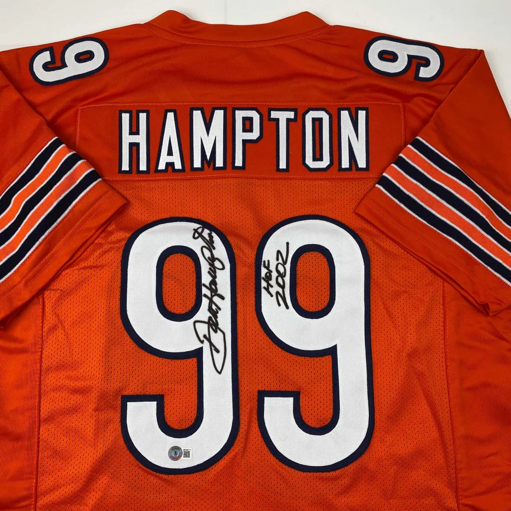Back of an autographed orange chicago bears custom jersey with white and black lettering featuring hampton 99 from professional sports league