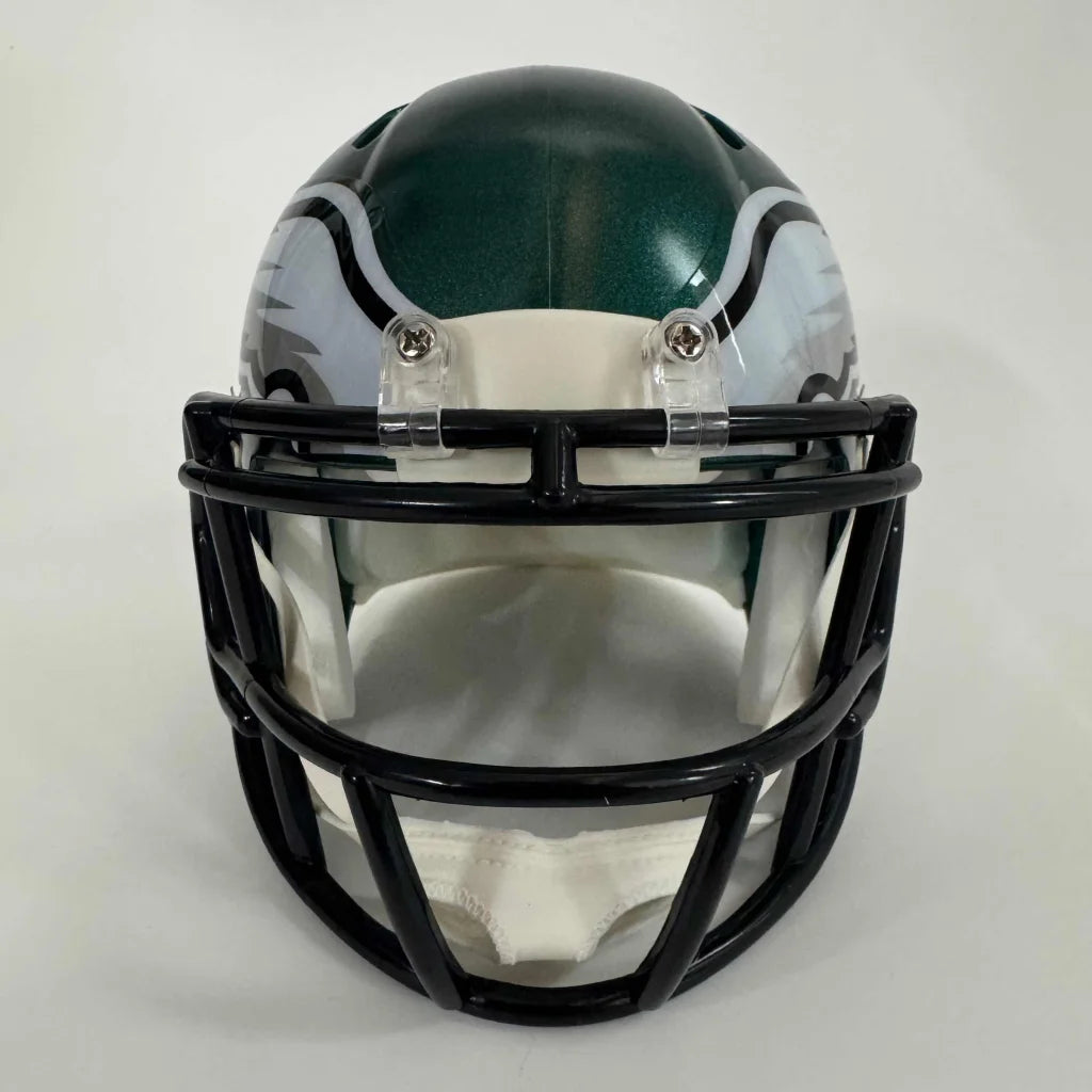 Green and silver football helmet with a black facemask.