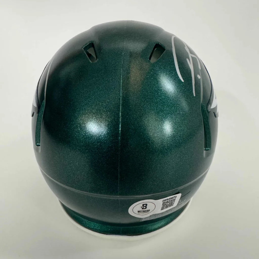 Dark green Philadelphia Eagles mini helmet with white autograph in display case