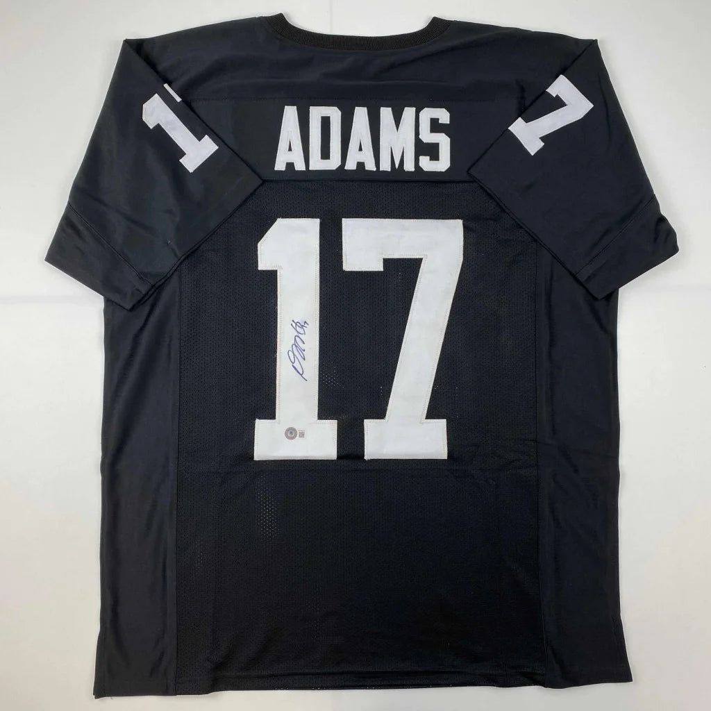 Back of autographed black davante adams football jersey with white lettering number 17 from professional sports league