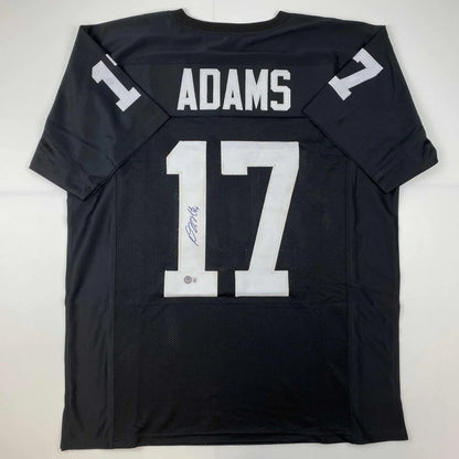 Back of autographed black davante adams football jersey with white lettering number 17 from professional sports league