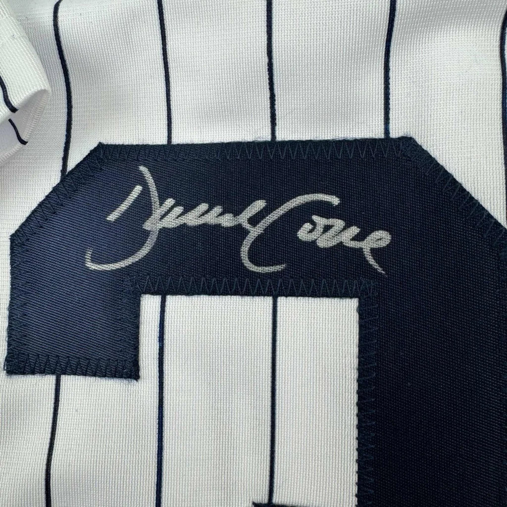 White and navy pinstriped custom jersey from professional sports league with navy number patch