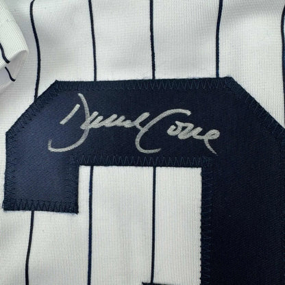 White and navy pinstriped custom jersey from professional sports league with navy number patch
