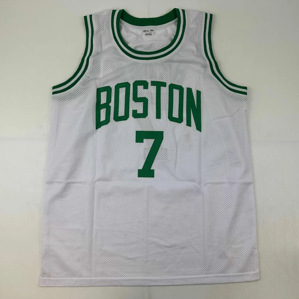 Autographed white mesh basketball jersey with green trim and Boston 7 printed in bold green lettering