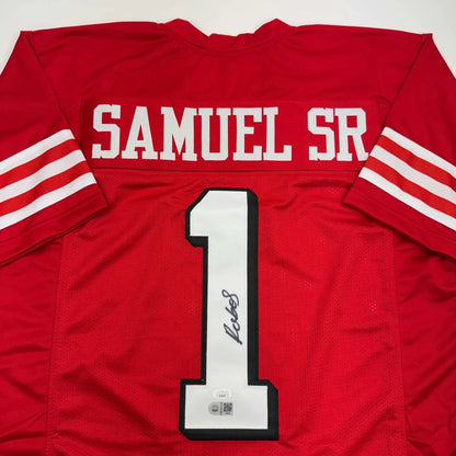 Red professional sports jersey with white stripes and signature, perfect for custom sports fans