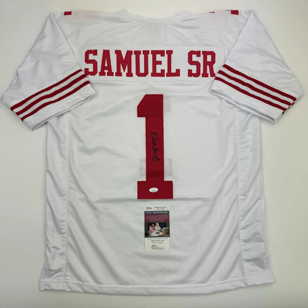 White professional sports league football jersey with red lettering and signed memorabilia