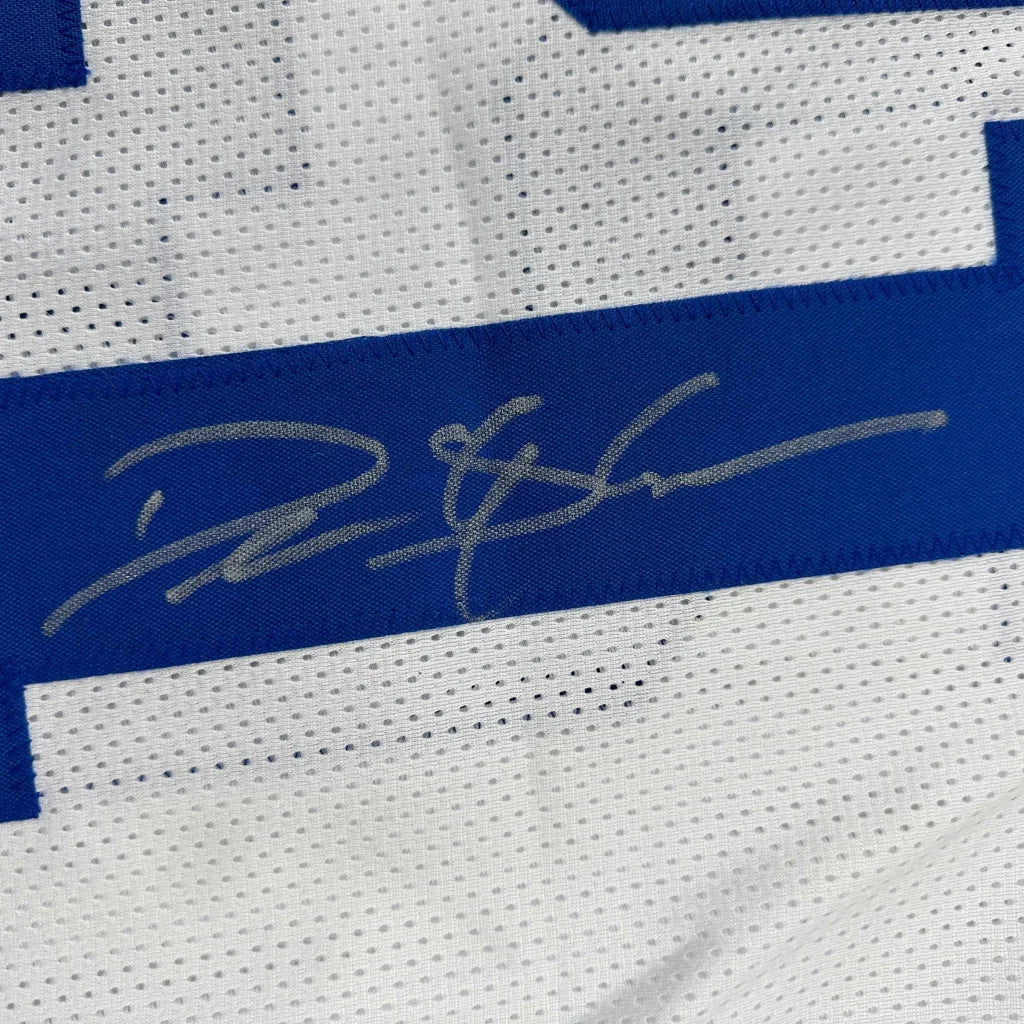 Silver autograph on blue stripe of white mesh custom football jersey from professional sports league with beckett coa