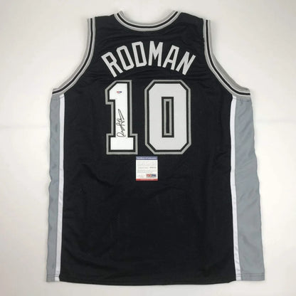 Autographed Dennis Rodman custom jersey in black with white and silver lettering, name Roodman and number 10, PSA/DNA COA, professional sports league